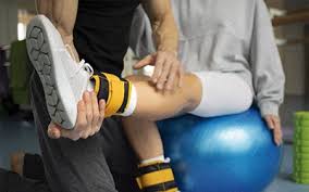  physical therapist guiding runner through strength exercise