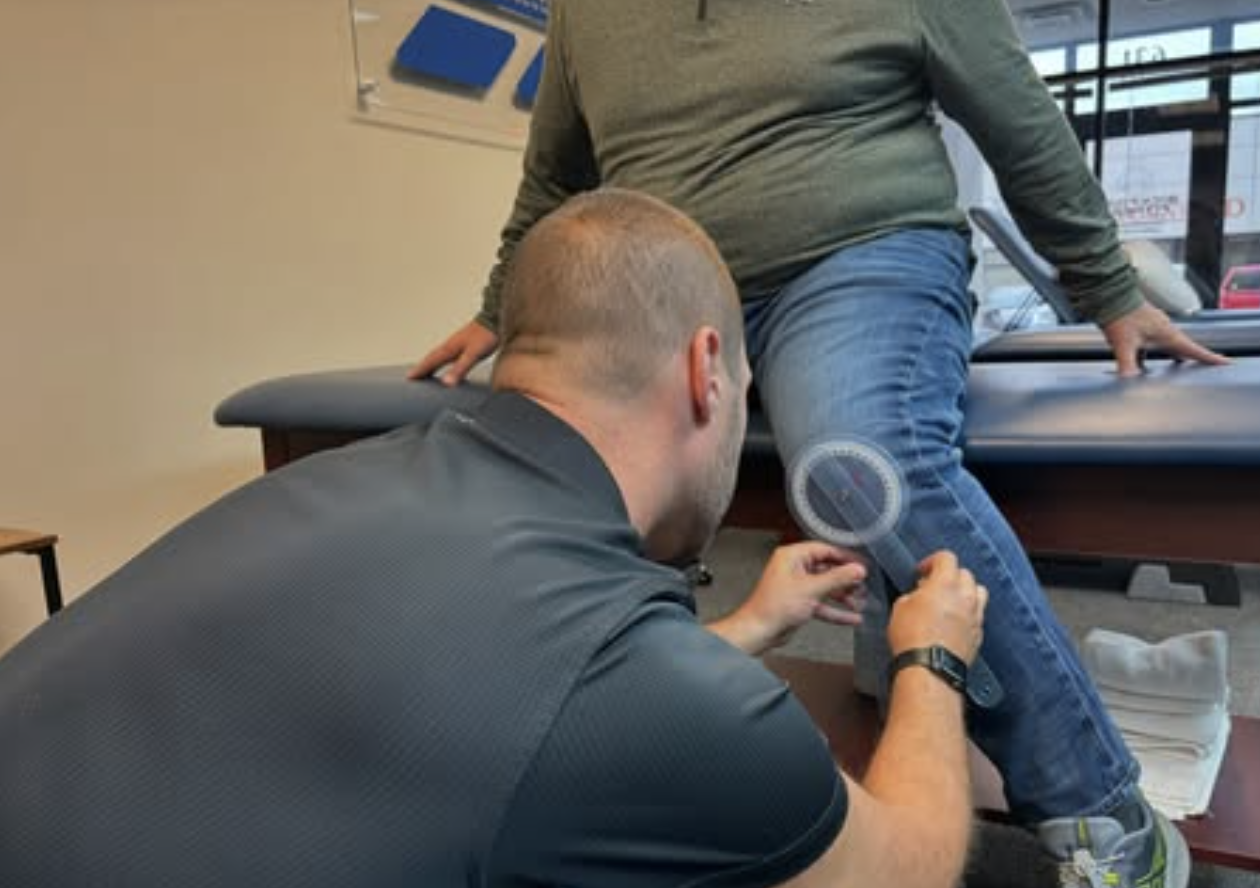 Patient working with a provider at a performance physical therapy clinic in Columbus, OH during a one-on-one movement assessment